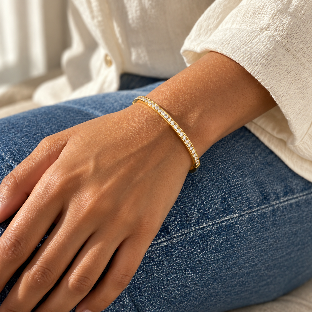 AI-generated lifestyle illustration of Lumière Slim Pavé Bangle – Gold-Tone Moissanite worn in an everyday setting.