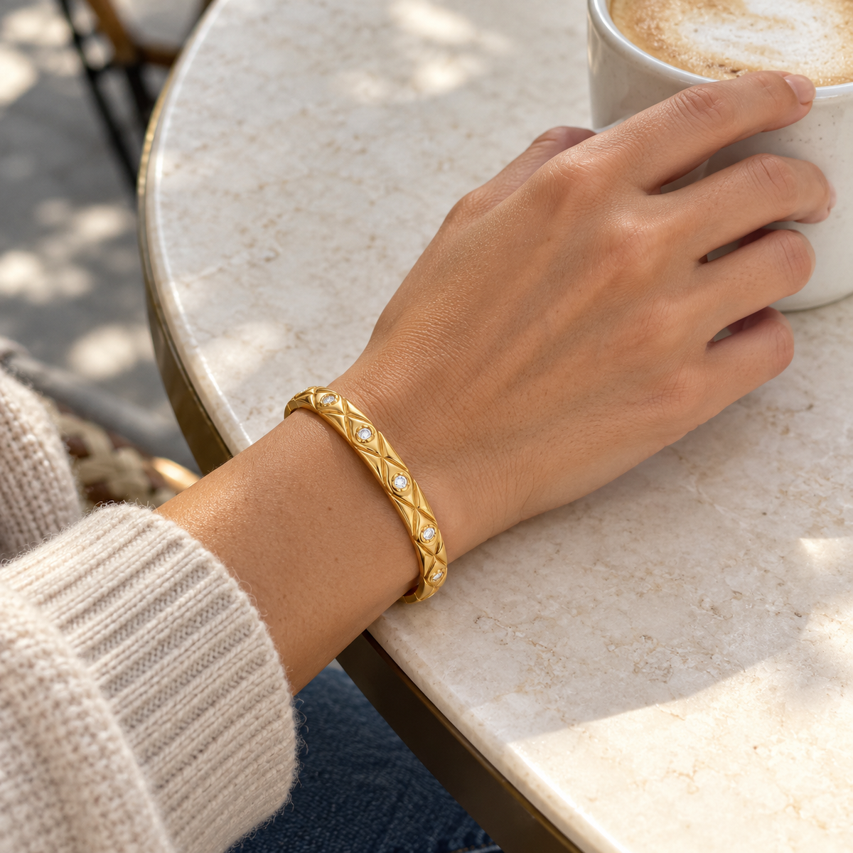 AI-generated lifestyle illustration of Elara Quilted Sparkle Bangle – Gold-Tone Moissanite worn in an everyday setting.