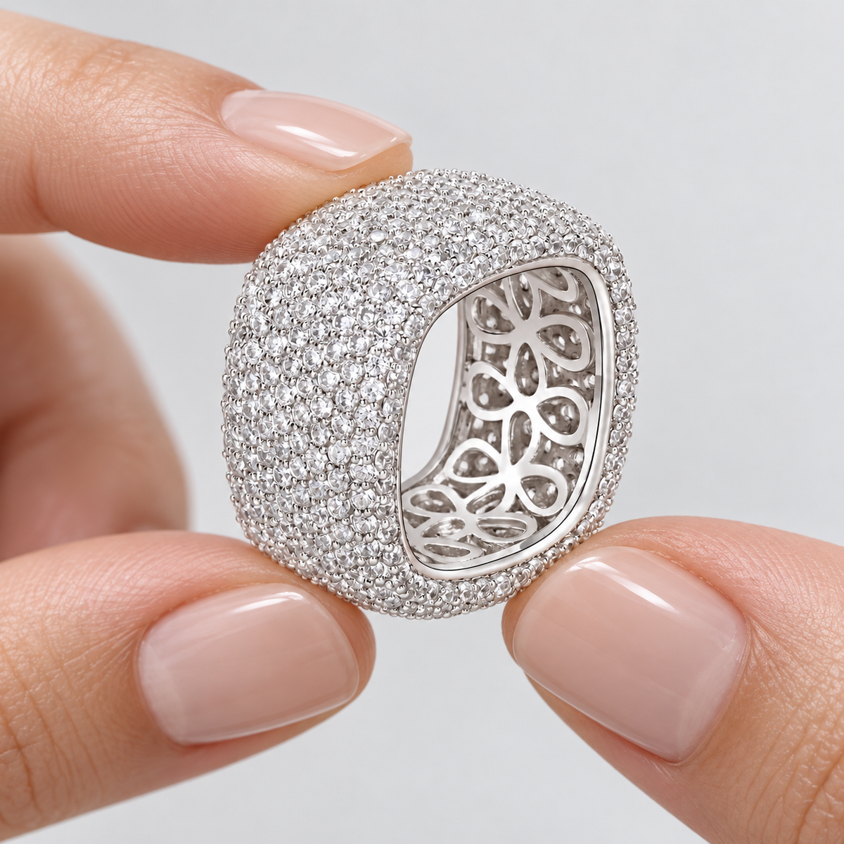 Hands presenting the Aurelia dome ring and floral openwork interior