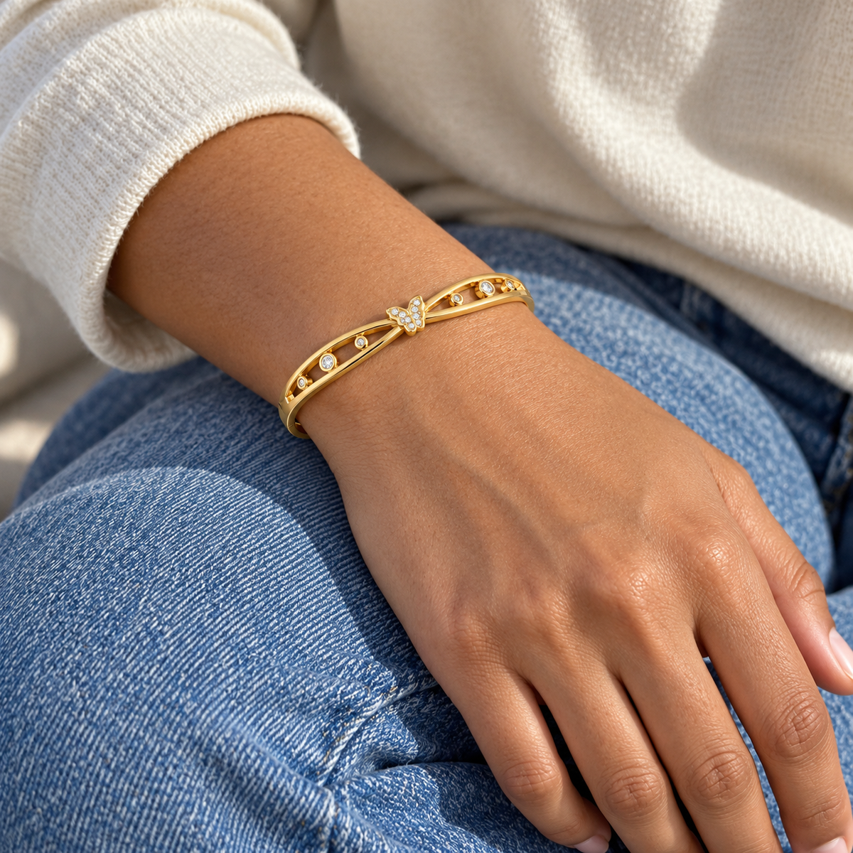 AI-generated lifestyle illustration of Celeste Butterfly Openwork Bangle – Gold-Tone Moissanite worn in an everyday setting.