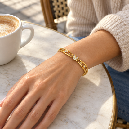 AI-generated lifestyle illustration of Celeste Butterfly Openwork Bangle – Gold-Tone Moissanite worn in an everyday setting.