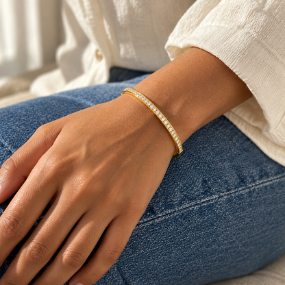 AI-generated lifestyle illustration of Lumière Slim Pavé Bangle – Gold-Tone Moissanite worn in an everyday setting.
