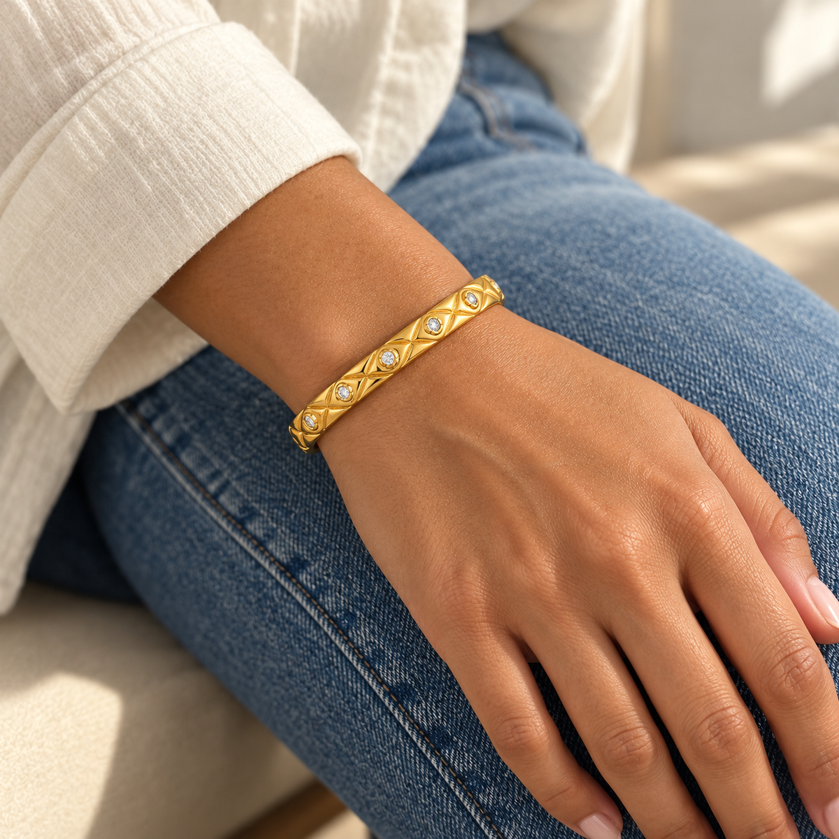 AI-generated lifestyle illustration of Elara Quilted Sparkle Bangle – Gold-Tone Moissanite worn in an everyday setting.