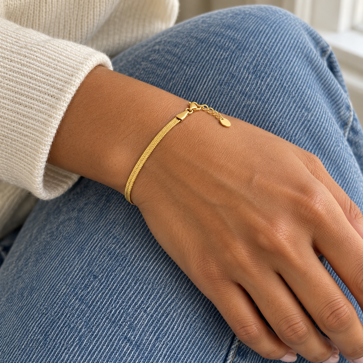 AI-generated lifestyle illustration of Serena Flat Snake Chain Bracelet – Gold-Tone worn in an everyday setting.