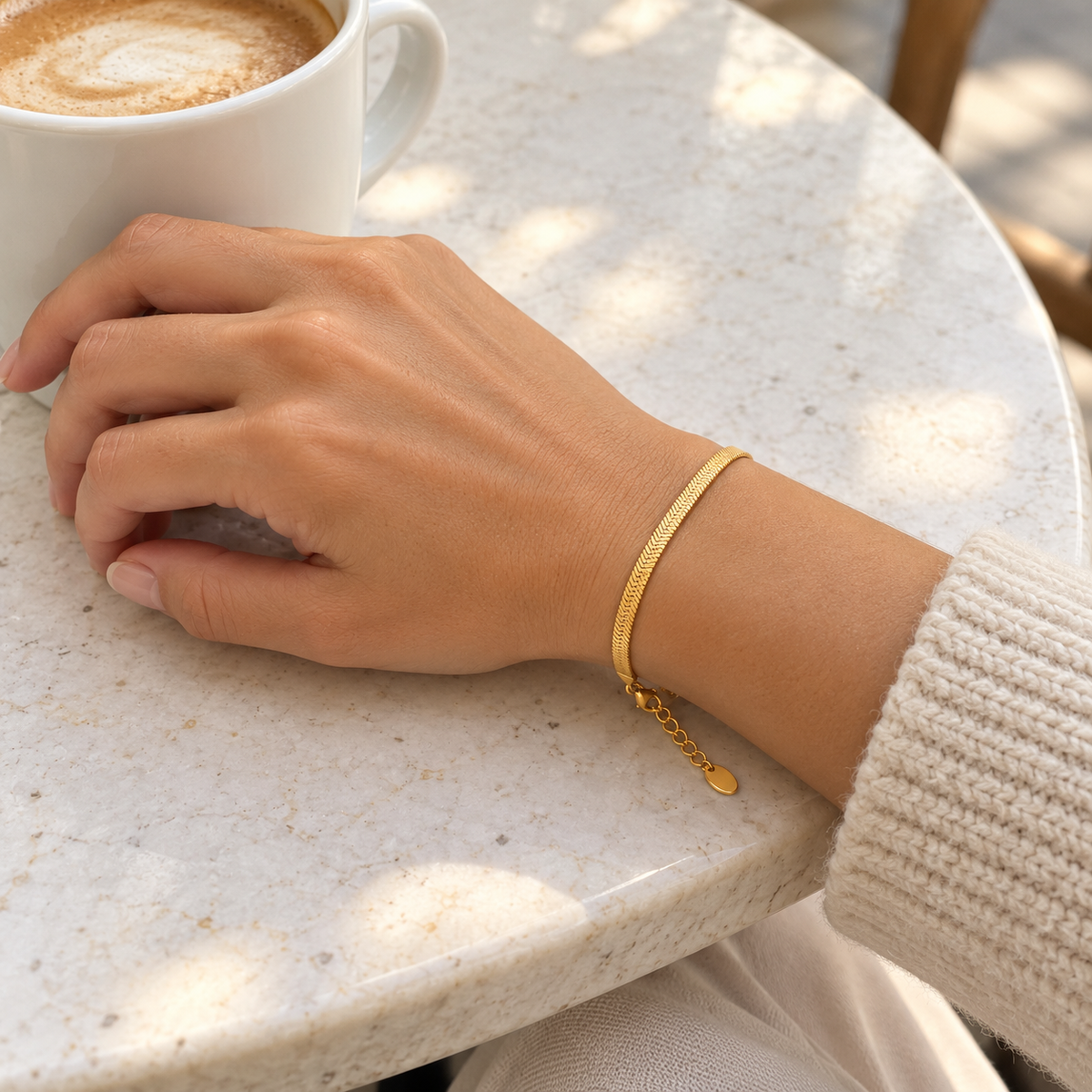 AI-generated lifestyle illustration of Serena Flat Snake Chain Bracelet – Gold-Tone worn in an everyday setting.