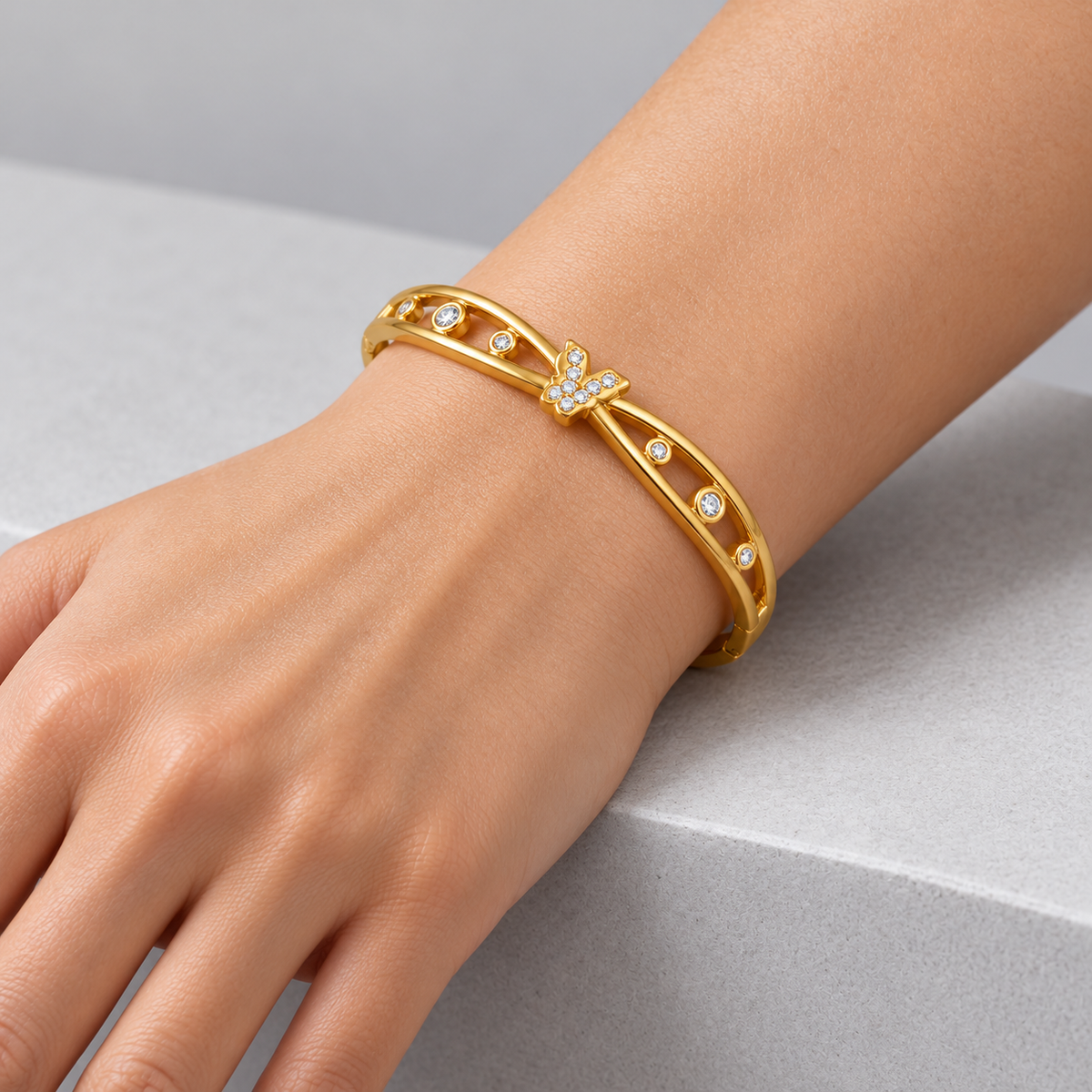Celeste Butterfly Openwork Bangle worn by a studio model
