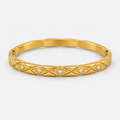 Elara Quilted Sparkle Bangle centered on a light gray background