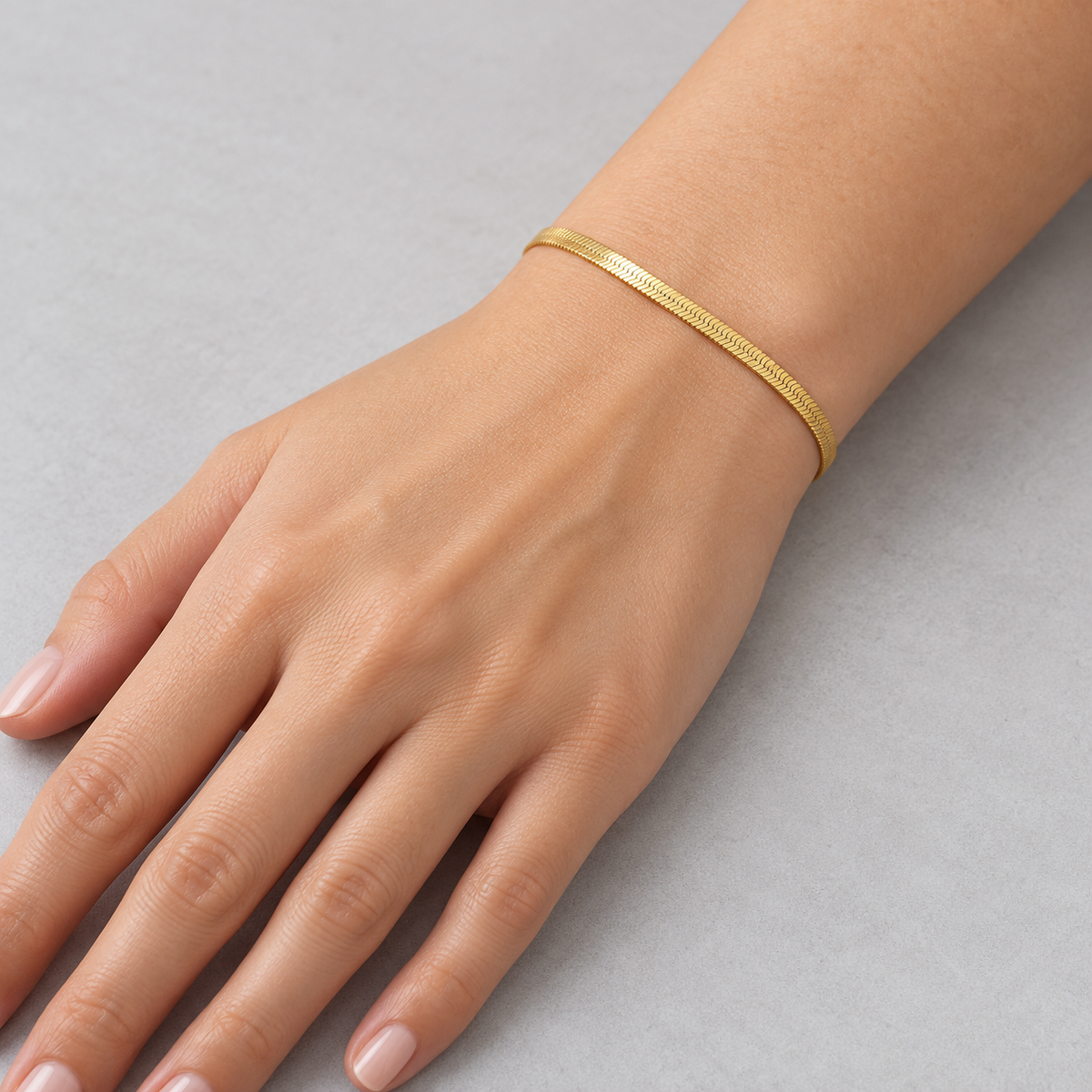 Serena Flat Snake Chain Bracelet shown on a model's wrist