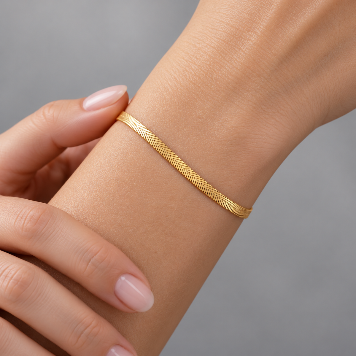 Serena Flat Snake Chain Bracelet shown on a model's wrist