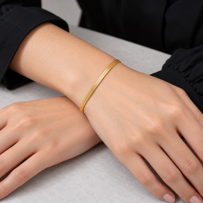 Serena Flat Snake Chain Bracelet shown on a model's wrist